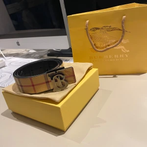 Reversibel Burberry Bälte  - Säljer ett snyggt Burberry bälte som knappt har använts. Bältet är reversibel och har därför olika 2 färger !! Kommer i originalförpackning.