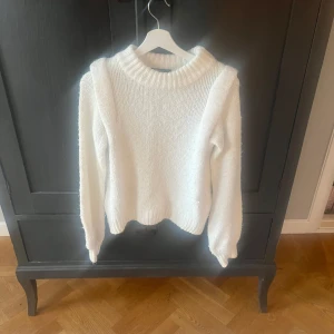Vit stickad tröja  - Säljer en supermysig vit stickad tröja . Den har en klassisk design med ribbad krage och långa ärmar. Tröjan är i bra skick och passar perfekt för både höst och vinter.  