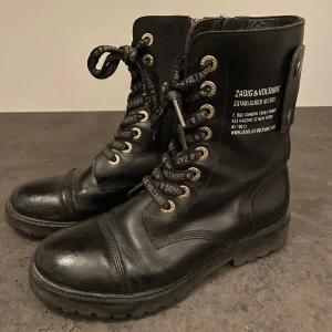 Svarta boots från Zadig & Voltaire - Hej! Säljer nu mina älskade Zadig kängor, de är supersköna och snygga! Smidiga med dragkedja på sidan, funkar till vardag och fest! Skickar med både dustbag och skokartong. Se sista bilden för slitage på ens skon, vårdar man dom rätt är det inget man tänker på. Nypris 4800 men säljes därför billigare❤️‍🔥 Postar endast!
