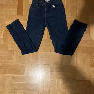 Mörkblå jeansbyxor - Snygga mörkblå jeansbyxor med en klassisk femficksdesign. De har en slim passform och är perfekta för en stilren look. Byxorna har en dragkedja och knapp framtill. Priset kan diskuteras 