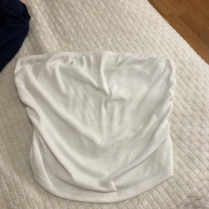 Vit ribbad tubtopp söt men simpel 💕 - Säljer en stilren vit ribbad tubtopp. Perfekt för varma sommardagar eller som ett basplagg i garderoben. Enkel och mångsidig design som passar till det mesta.