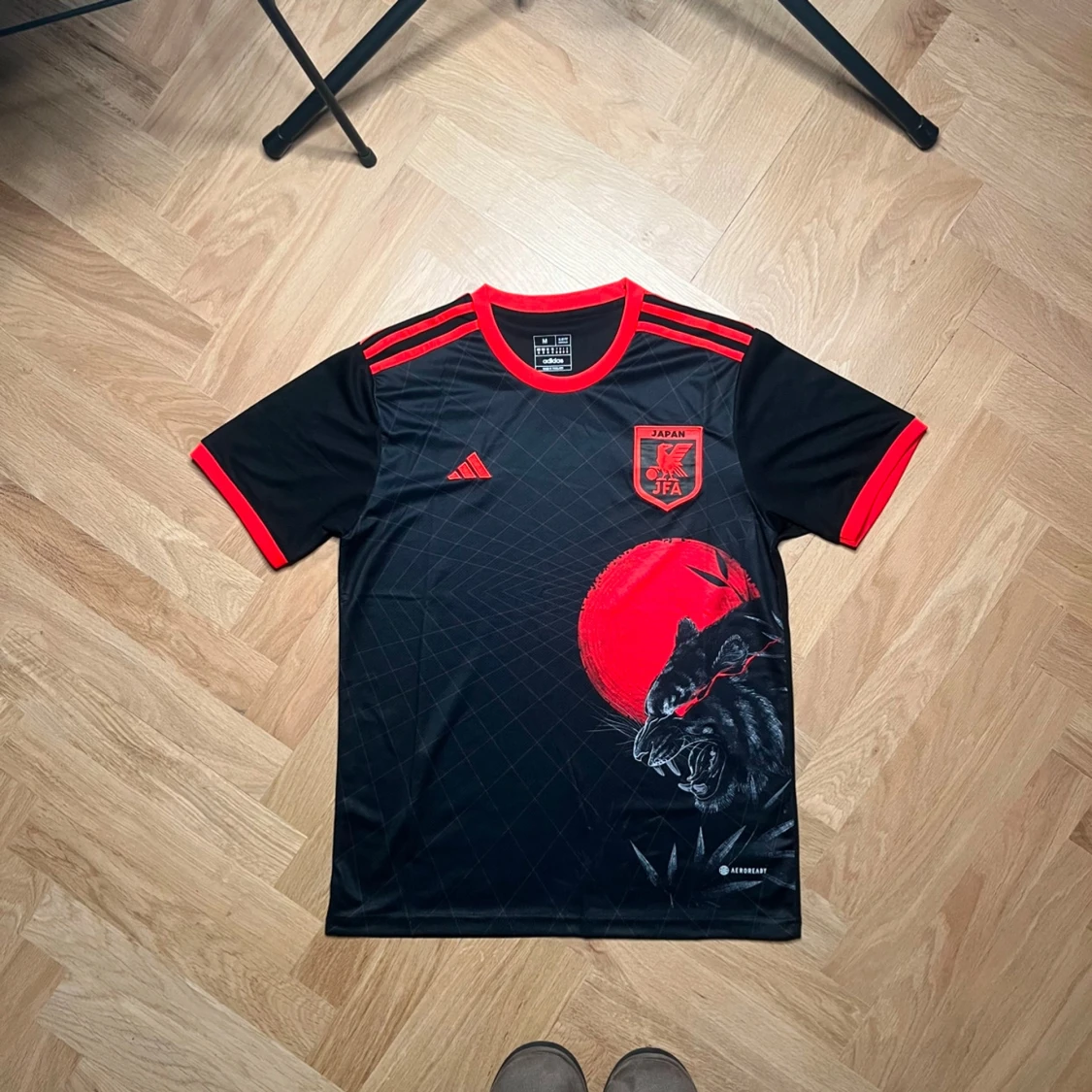 En Japan fotbolls tröja, Svart och röd med vargmotiv