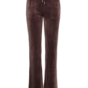 Bruna juicy byxor - Säljer ett par snygga bruna velourbyxor i bootcut-stil. De är mid waist men går såklart att vika ner vid midjan ifall man vill ha low. Har snörning i midjan och har praktiska fickor både fram och bak. Perfekta för en avslappnad look eller mysiga dagar hemma. Supermjuka och bekväma! Skriv privat för egna bilder, litet hål i ena fickan där fram men absolut inget som syns. Nästan alls faktiskt.                                                     Köpt på Juicys hemsida för 1200 kr!