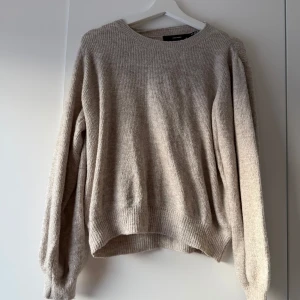 Beige stickad tröja från Vero Moda - Mysig beige stickad tröja från Vero Moda i storlek XL Perfekt för höst och vinter med sin varma och bekväma passform. Tröjan har långa ärmar och ribbade muddar vid ärmslut och nederkant. Enkelt och stilrent plagg som passar till det mesta. 🧶✨