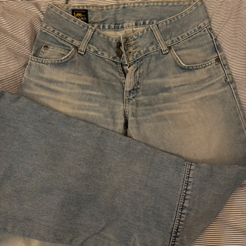 Jättesnygga jeans från Lee med coola detaljer på knänan! Väldigt bra skick men säljer tuvär då de inte passar. Perfekta till alla tillfällen och är lågmidjade. Fråga om ni har några frågor🩷 Midjemått= 37cm Grenhöjd=22cm Innerbenslängd= 78cm. Jeans & Byxor.