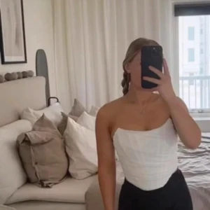 Vit axelbandslös topp - Snygg vit axelbandslös topp som passar perfekt till både vardag och fest. Den har en stilren design och är lätt att matcha med olika outfits. Som en korsett fast med dragkedja baktill. Använd en gång