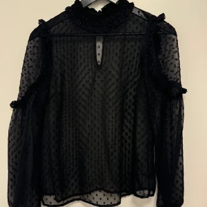 Svart prickig genomskinlig meshblus - Såå fin festblus, svinsnygg me typ ett linne eller bralette under, använder tyvärr inte längre. Nyckelhålsöppningen är i bak vid nacke/rygg🩷🩷