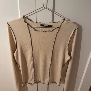 Beige ribbad tröja från BikBok - Säljer en beige ribbad tröja från BikBok med svarta kanter. Storlek L (liten i storlek)