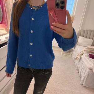 Blå kofta med knappar🎀 - Säljer en snygg blå kofta med vita knappar. Koftan har långa ärmar och en normal passform, perfekt för att hålla sig varm och stilren. Super cool färg💘💘💘