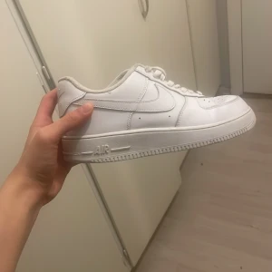 Vita Nike Air Force sneakers - Säljer ett par klassiska vita Nike Air Force sneakers. De har en stilren design med snörning och en robust sula. Perfekta för vintern men även skön. 42/41 pris kan såklart diskuteras