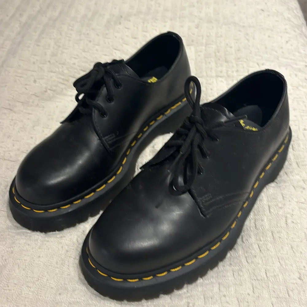 Säljer ett par svarta, plattform, låga Dr. Martens skor i storlek 39. Skorna är i skinn och har den klassiska gula sömmen runt sulan. De är i toppskick och har en sula som ger bra grepp. Perfekta för både vardag och fest! Jag accepterar ofta rimliga prisförslag!🤗. Skor.