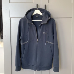Hugo boss zip hoodie - Använd ett fåtal gånger pågrund av snabb uppväxt. Den är ganska töjbar och kan användas även om man är en storlek större. 