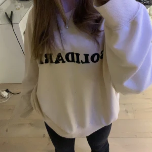 Beige sweatshirt - Snygg och enkel beige sweatshirt med text på. Köpt för något år sedan här på plick. Storlek L och sitter då lite oversized på mig!