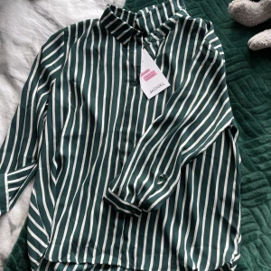 Blus - Asfin grön vit randig blus som är helt oanvänd. Riktigt fin. Men den kom inte till användning och blev för liten.