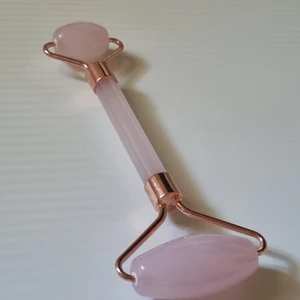 Ansikts roller i rosenkvarts - Ansikts roller i rosenkvarts för ansiktsmassage. Massera in olja/krämer med denna underbara roller.   Frakt = 26kr  Totalt för frakt och roller: 41kr. Skickas i vadderat kuvert. 