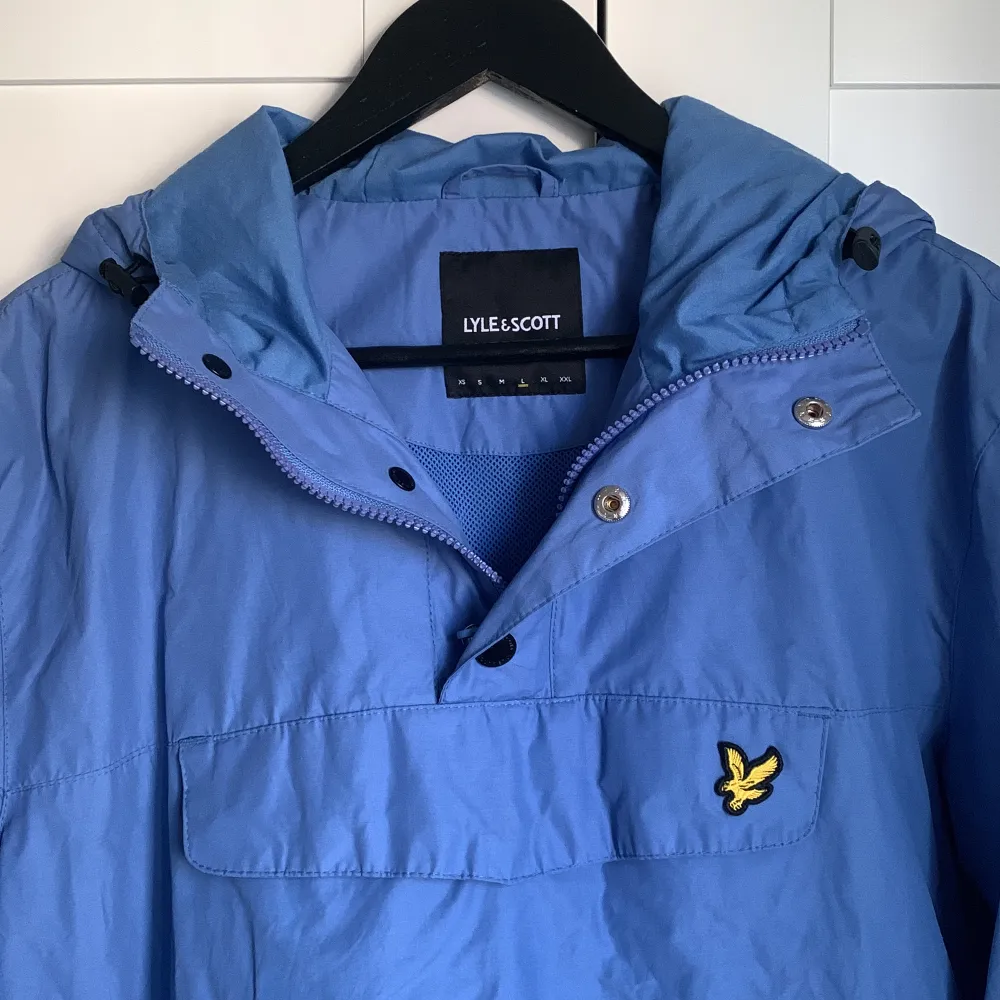 Klarblå Lyle & Scott anorak i strl L, men skulle säga att den passar M/L. Dragkedja i kragen och på sidorna, Inköpspris 1350 kr, säljer för 800💞 Nyskick, andvänd 1 gång! (Sista bilden är lånad från hemsidan men i en annan färg). Takit.