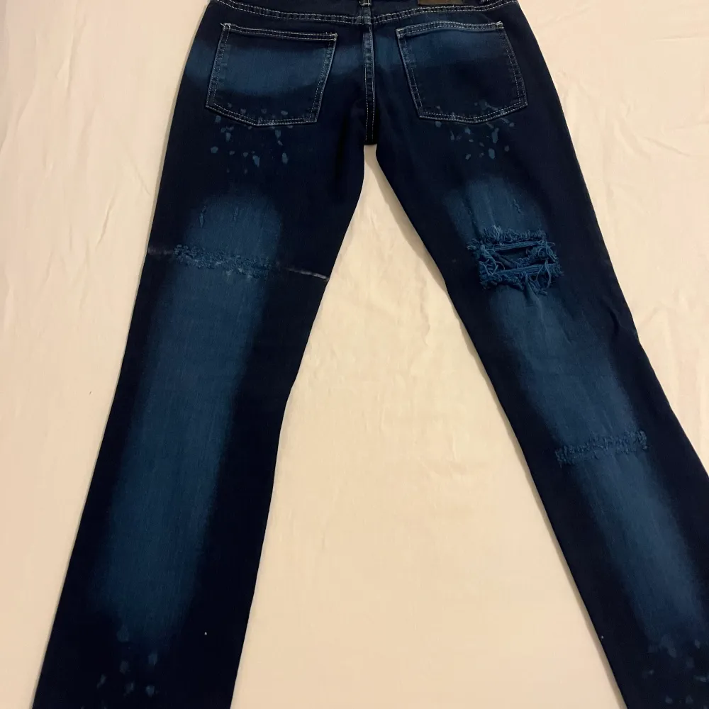 Mörk blåa jeans med små ljusa delar på jeansen. De är köpta i London 2006. Storlek på jeansen är 26.. Jeans & Byxor.
