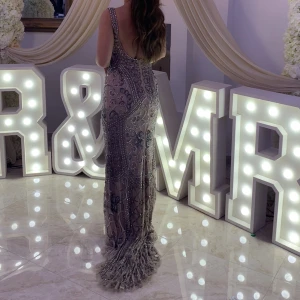 Balklänning med släp och öppen rygg  - Unik balklänning/ aftonklänning med paljetter och stenar. Mauve färg med gråa/ silvriga stenar. Släp. Bar rygg. Köpt för 7000kr, pris går att diskuteras!