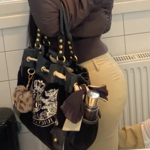 Juicy Couture DayDreamer vintage handväska y2k - Så fin Juicy Couture väska i bra skick, sparsamt använd. Rymmer en del och det går att justera bandet. Inköpt dyrt och de flesta går för över 2000kr! ✨ Slitningar på lädret som det är på alla Juicy väskor. Fråga om det är något du undrar över :)