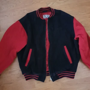 Poco loco Alpha Bomberjacka - Höstjacka i filt, går även bra att ha på vintern med en tunnare fodrad skaljacka under. Lagom oversize bomberjacka. Svart och röd med fejdat tryck. Riktig retro känsla. Glöm inte kolla övriga annonser <3