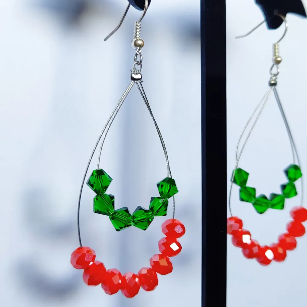 Handmade earrings with green and orange beads, new. Accessoarer.