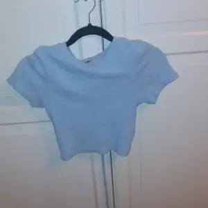 Blå tröja med lite öppen baksida. Aldrig använt, tvättad innan