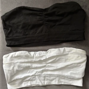 Topp - Säljer två stycken tub toppar från Gina Tricot, en svart och en vit, den vita har en liten fläck på sig men går säkert o få bort. Säljer på grund av att de aldrig kommer till användning 