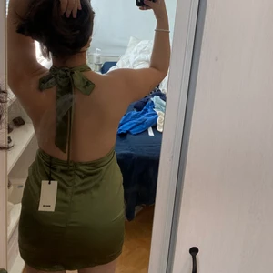 Klänning med öppen rygg - Detta är en oanvänd grön klänning köpt på Bikbok som inte kom till användning, original priset är 400kr och prislappen är även på💕