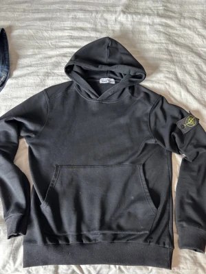 Svart hoodie från Stone Island - Säljer en svart hoodie från Stone Island med klassisk patch på vänster ärm