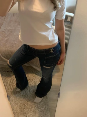 Vit basic T-shirt  - En enkel och stilren vit t-shirt med rund hals och korta ärmar. Modellen har en normal passform och är tillverkad i mjuk bomull som känns skön mot huden. Perfekt att matcha med jeans eller shorts.