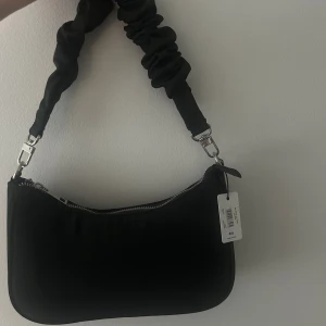 Svart väska  - Svart väska från Bik Bok, aldrig använd och prislappen sitter kvar. 