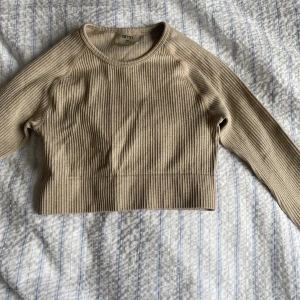 Långärmad Träningstopp Aimn - Säljer en beige långärmad träningströja från Aimn. Sparsamt använd. Strl XS