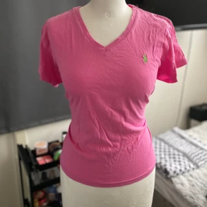 Rosa ralph lauren T-shirt  - Säljer denna så vackra somriga ralph lauren T-shirt vringning bra kvalite 