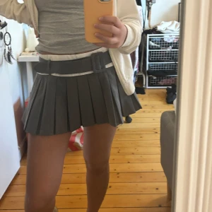 Grå kjol - Midja 40 cm längd 28 cm. Skulle gissa på storlek S, aldrig använd för stor på mig. Skärpet går att ta loss