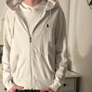 Ralph Lauren huvtröja - Stilren Ralph Lauren tröja köpt på Johnells för ett år sedan. Har några fläckar vid högra axeln samt en fläck under ryggen men det går säkert att ta bort med rätt medel! Självklart äkta!