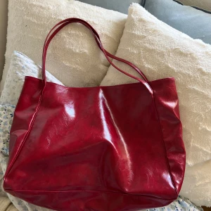Röd väska - Stor praktisk väska som får plats med mycket. Säljer då den inte kommer till användning för mig. Stängs med magnetknapp. 40 cm i bredd, 30 cm i höjd, 13 cm i djup. Skriv för frågor 🧡