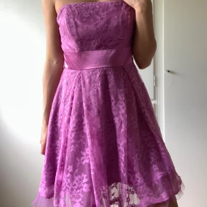 Ljuslila bandeauklänning - Dragkedja i sidan. Knyts med band bakom ryggen.