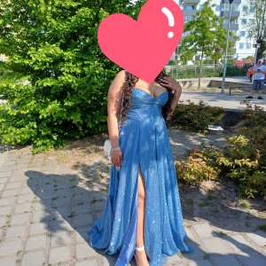 Balklänning från prooms and weddings  - Elegant fin klänning från Ladivine by cinderella divine. Strl 16 passar stor M-XL då den har korsett snörning bak. Den har hög slits på hö ben och två djupa diskreta fickor på sidorna. Köpt för 3000kr i maj 2023. Använd 1 kväll Kvitto+bag medföljer.