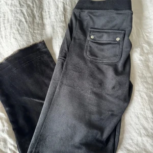 Juicy byxor stl L - Svarta juicy cotoure byxor i stl L. Använda 1 gång. Ej tvättade. Påbörjade en uppläggning, men har inte sytt upp dom. Passar om man är ca 1,57.