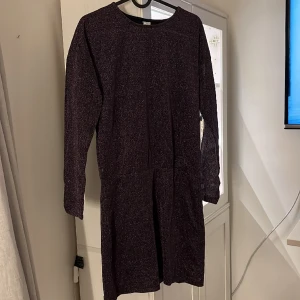 Klänning - Glittrig klänning från Lindex. Barnstorleken 170 men sitter som en xs/s. Lila/svart i färgen. Köparen står för frakten!