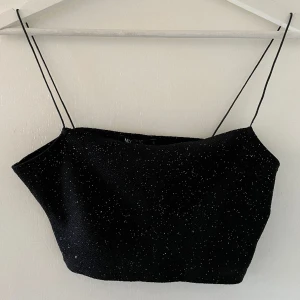 Glittrig topp - Glittrig croppad topp från Nelly! Fint skick. Så snygg under t.ex en kavaj!