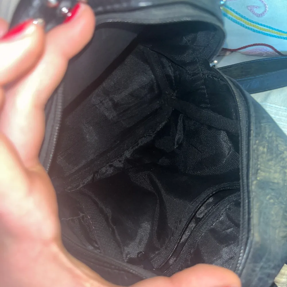 En liten svart ryggsäck med nitar i fakeskinn. Inga tecken på slitage heller.  Skriv vid intresse eller för mer info:). Väskor.