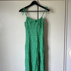 Grön klänning  - En grön klänning med vita små blommor från hm