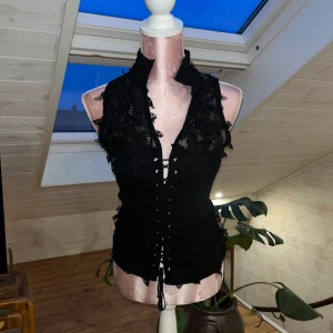 Topp - Topp med spets detaljer och snörning framtill🖤står storlek M/L men sitter som en S