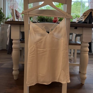 Satintopp med knytning i ryggen  - Topp i satin med knytning i ryggen från HM!💗💞 Är i storlek XS✨ DM för fler bilder och frågor❣️❣️Endast använd 2 gånger❤️