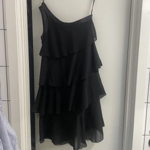 Volang klänning - Klänningen blev inte såld!  As fin one shoulder volangklänning, nästan aldrig använd pga lite för liten💕 Bandet till höger är endast något man använder för att hänga upp den, så den syns inte när klänningen är på!☺️  