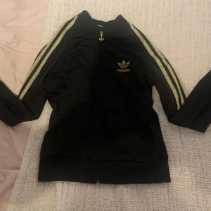 jätte snygg adidas zip-up!! - snygg svart adidas kofta med guldiga detaljer, men som tyvärr inte kommer till användning längre! hör av dig för bilder på!💓💓