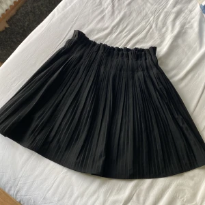 Svart pläterad kjol - Superfin plisserad kjol från Zara med korta fastsydda inneshorts i satin. Använd max 3 gånger. Storlek S