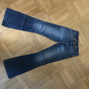 Levi’s jeans med röd detalj! - Skulle uppskatta storlek S/M. Midwaist! Har en snygg röd söm på benen.