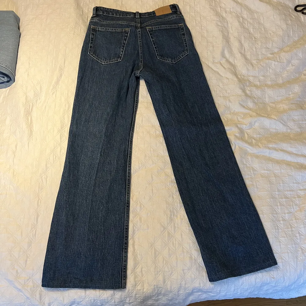 Ett par jeans från Weekday i modellen Glow. De är använda 1 gång så de är i fint skick. OBS! Jag har sytt upp dem så de skulle passa mig som är cirka 155 cm lång, jag är amatör och kan inte garantera att det är en perfekt söm. Köps i befintligt skick.. Jeans & Byxor.